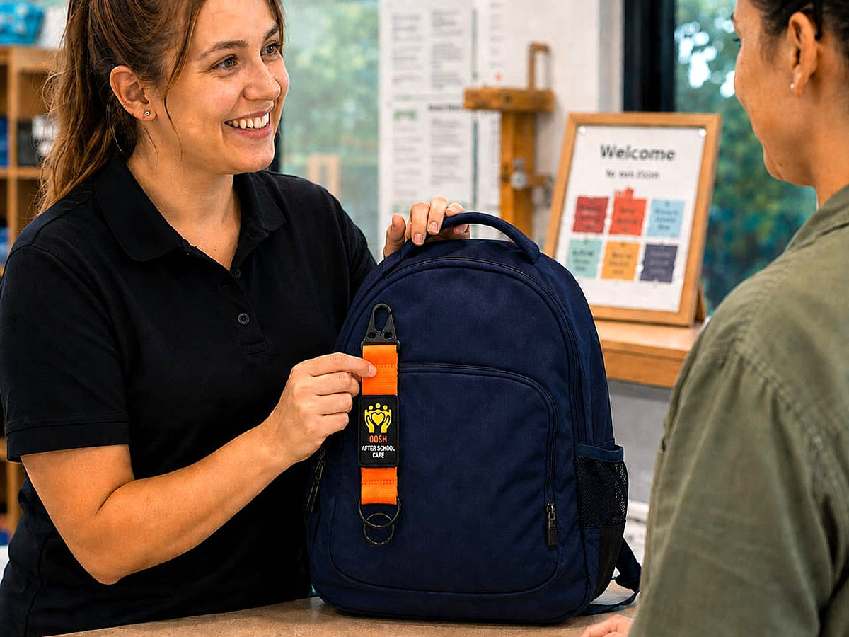 DuraKid OOSH Care bag tag clipped to a school backpack